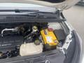The image shows the engine compartment of a 2018 Buick Encore featuring components like the battery a coolant reservoir and various engine parts