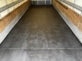 A 2006 Hino 268 truck with a clear rubberized floor in the cargo area, showcasing its spacious interior designed for transporting goods