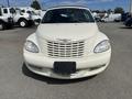 A 2005 Chrysler PT Cruiser with a light beige exterior and distinctive front grille showcasing horizontal slats and the Chrysler emblem