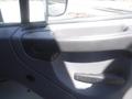 A close-up of the door handle and interior panel of a 2005 Freightliner M2 106 Medium Duty truck