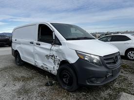 A 2018 Mercedes-Benz Metris with a damaged side and black wheels parked at a lot