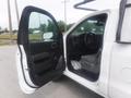 A 2015 Chevrolet Silverado 1500 with an open driver's side door showing the interior featuring a steering wheel and front seat