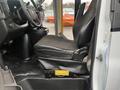 2018 Chevrolet Express passenger seat with black fabric upholstery and console featuring cupholders