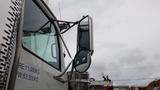 A 2019 Western Star Trucks 4900 with a chrome side mirror and a reflective surface highlighting the vehicle's design and build