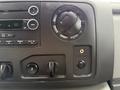 Dashboard controls of a 2013 Ford Econoline including audio system buttons and climate control knobs