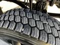 Close-up of a tire with a deep tread pattern showing grooves and ridges designed for traction and grip on the road