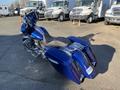 A 2017 Harley-Davidson FLHXS in a deep blue finish featuring a touring design with dual saddlebags and a stylish seat