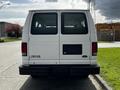 A white 2004 Ford Econoline E350 van viewed from the rear with a black bumper and no visible license plate