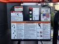 Control panel of a 2000 JLG 12SP with warning signs including danger, electrification, falling hazards, and operational instructions