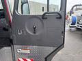 A close-up view of the door of a 2006 E-One Typhoon fire truck featuring a circular handle and a rectangular panel with a lock mechanism