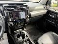 Interior dashboard of a 2021 Toyota 4Runner featuring a touchscreen display climate controls gear shifter and leather seats