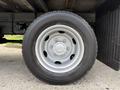 A close-up of a silver wheel and tire of a 2018 Hino 195 showing the tread pattern and metal rim with bolts visible