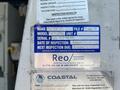 A 2008 Ford E-350 vehicle with a blue inspection label attached, detailing the make model serial number inspection date and next inspection due