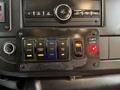Dashboard controls of a 2019 Chevrolet Express featuring buttons for interior lights door functions and a shift lock indicator