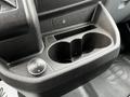 Cup holder and 12V power outlet in the center console of a 2017 Ford Transit 350