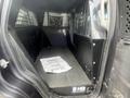 Interior view of a 2016 Chevrolet Tahoe with a black metal divider and a flat surface designed for transporting cargo or equipment