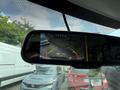 A rearview mirror display shows a backup camera view with guidelines for parking and surrounding vehicles including a gray Honda and a red SUV