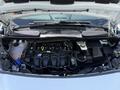The engine compartment of a 2021 Ford Transit Connect showing the engine components and associated parts