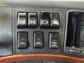 A control panel from a 2005 Volvo VND featuring six black switches labeled for auxiliary functions and engine air control
