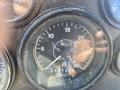 A close-up of a vehicle speedometer displaying the speed in miles per hour with a reading of 15 and a mileage indicator showing 0177502 miles