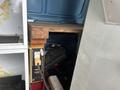 A 2006 Ford Econoline with a wooden shelf and tools visible inside the vehicle's cargo space