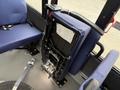 2020 Chevrolet Express interior featuring blue fabric seating with a folded seatback showing wiring and controls attached to the frame