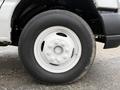 Close-up of a white wheel and tire from a 2019 Ford Econoline showing the tire tread and five spoke wheel design