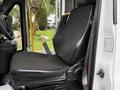 A black fabric driver's seat from a 2015 Chevrolet Express with a seatbelt visible on the right side. The seat is positioned in a van's interior