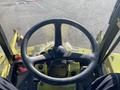 The steering wheel of a 2010 Kubota F3680 with control levers and dashboard visible in the foreground