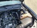 Engine compartment of a 2019 Dodge Charger featuring a large V8 engine and various engine components visible along with a coolant reservoir and air intake