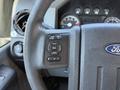 Close-up of the steering wheel controls in a 2012 Ford F-350 SD featuring buttons for information settings and cruise control