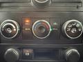 The dashboard climate control panel of a 2013 Chevrolet Silverado 3500HD featuring three rotary knobs and indicator lights for temperature and airflow settings