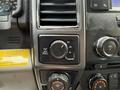 Interior dashboard controls of a 2018 Ford F-150 featuring knobs for drive modes and volume settings with illuminated indicators