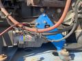 A 1997 Genie S-65 4X4 with visible wires and components connected to its engine including a control unit and various hoses