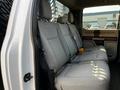 Interior of a 2021 Ford F-550 showing rear seats with gray fabric upholstery and seat belts