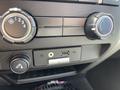 Dashboard controls of a 2012 Ford F-150 featuring air conditioning dials a USB port and a SYNC interface