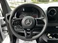 A 2020 Mercedes-Benz Sprinter steering wheel featuring a central logo buttons for controls and a digital dashboard in the background