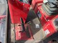 A red Toro Groundmaster 5910 seated mower control panel featuring a console with various controls and a footrest designed for operator comfort