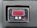 Close-up view of a Rayco Wylie wireless anti-two-block indicator with a red screen displaying status and low battery warnings