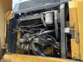 A close-up view of the engine compartment of a 2018 John Deere 350 showcasing intricate hoses filters and machinery components