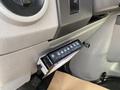 A 2009 Ford Econoline's dashboard featuring a digital control panel with buttons for various functions