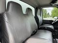 Two gray vinyl seats in a 2022 International MV607 truck's cabin, designed for driver and passenger with seatbelts visible