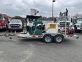 A 2011 Hightliner Aquacide Hot Water Weed Control Dual Flat Deck Trailer featuring a green machine with hoses and a caution sign indicating hot water weed control
