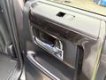 Close-up of the interior door handle of a 2021 Toyota 4Runner with a sleek design and chrome accents
