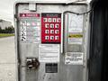 2016 Ford F-550 truck with crane controls and safety warning signs on the door
