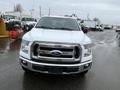 A front view of a white 2016 Ford F-150 truck with a chrome grille and a bold Ford logo