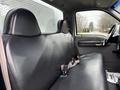 Interior view of a 2000 Ford F-450 showing a black vinyl bench seat and seatbelt in the driver's cabin