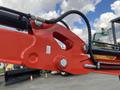 Close-up view of the hydraulic mechanism on a 2024 AGT Mini Excavator featuring red metal components and hydraulic hoses connected with bolts and fittings