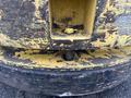 Close-up of a weathered 2000 Hyster 120 forklift tire showing worn yellow paint and rusted metal components