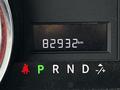 A close-up view of the dashboard of a 2011 Dodge Grand Caravan showing the odometer reading of 82932 km and the gear selector indicator with park reverse neutral drive and low settings